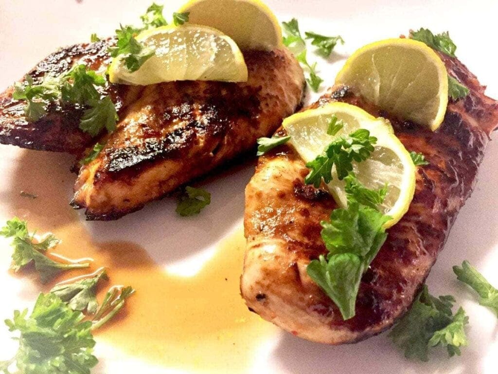 Chile Lime Chicken with limes on a white plate