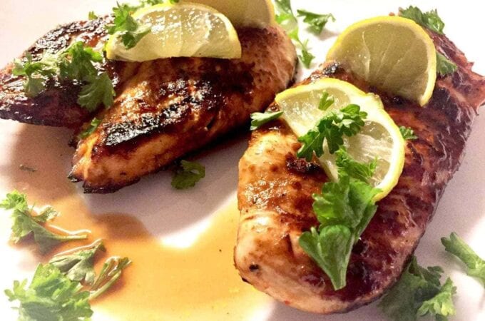 Chile Lime Chicken with limes on a white plate