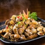 steamed clams on a blue plate