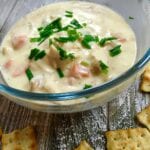 A bowl of chicken soup on a rustic table