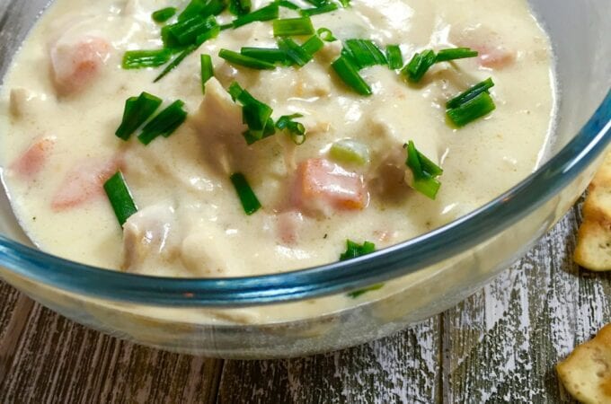 A bowl of chicken soup on a rustic table