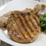 Grilled pork chops on a white plate