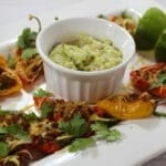 Fajita poppers surrounding a bowl of guacamole