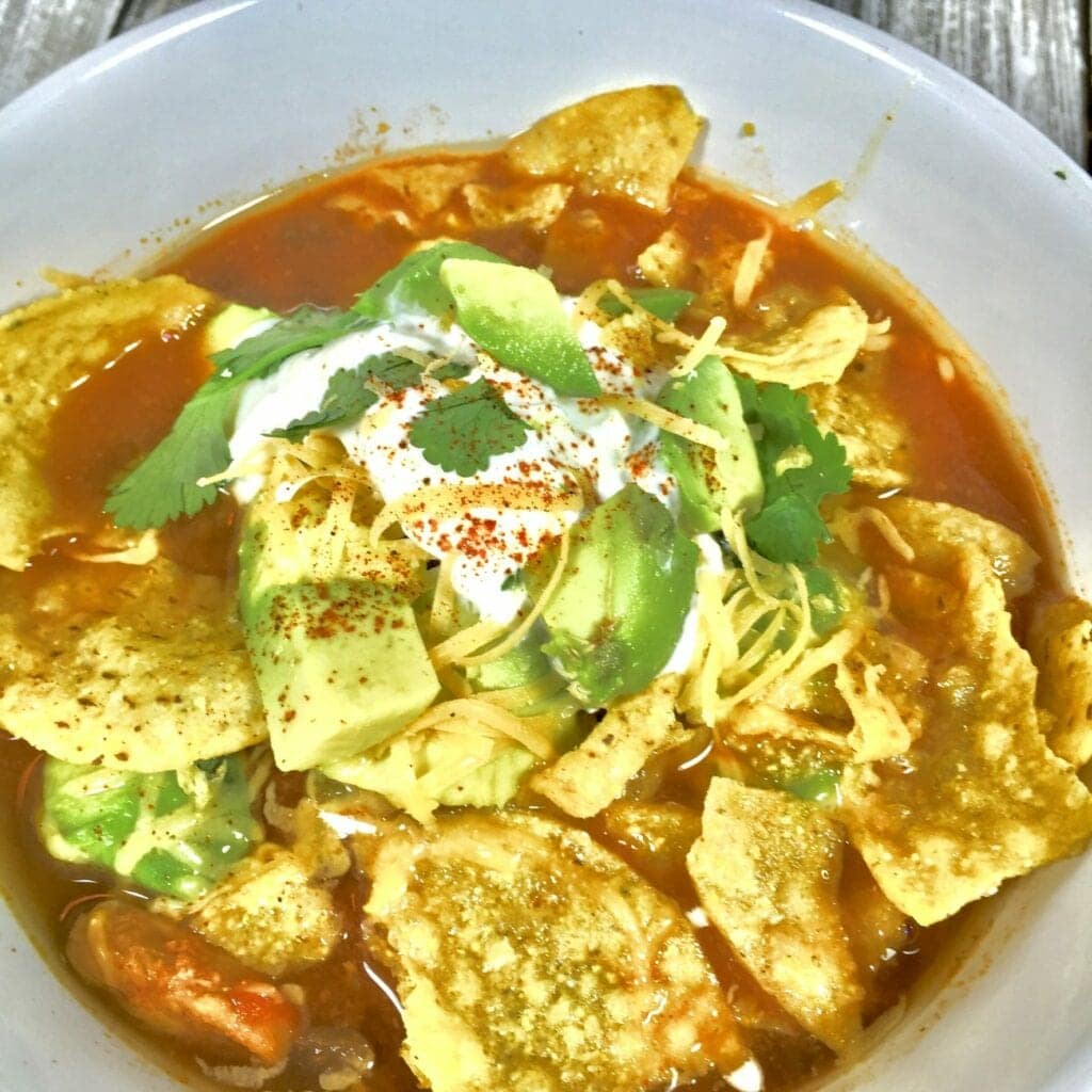 Tortilla soup in a white bowl