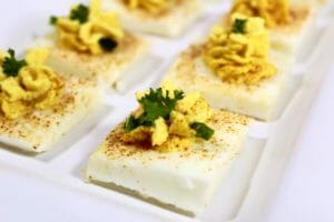square deviled eggs on a white plate