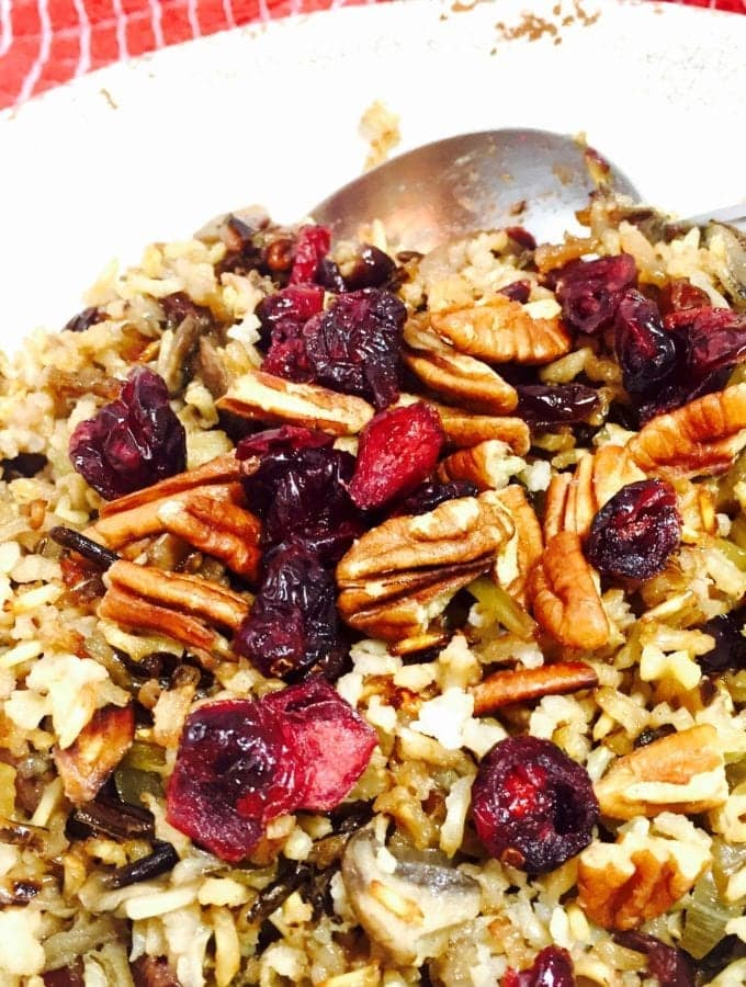 Wild rice with cranberries and pecans on a white plate