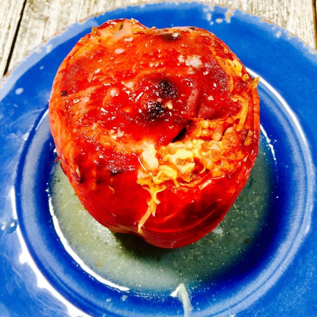 baked stuffed pepper on a blue plate