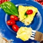 bit on a fork of a frittata on a blue plate