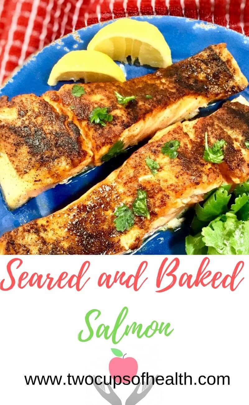 baked salmon on a blue plate with lemons and parsley