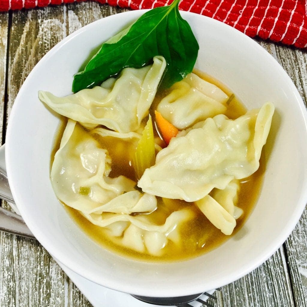 chicken dumpling soup in a white bowl