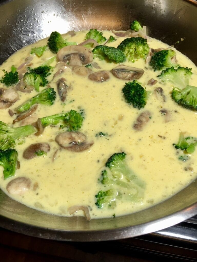 cooking a broccoli mushroom frittata in a pan