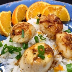 Sauteed sea scallops over rice with oranges