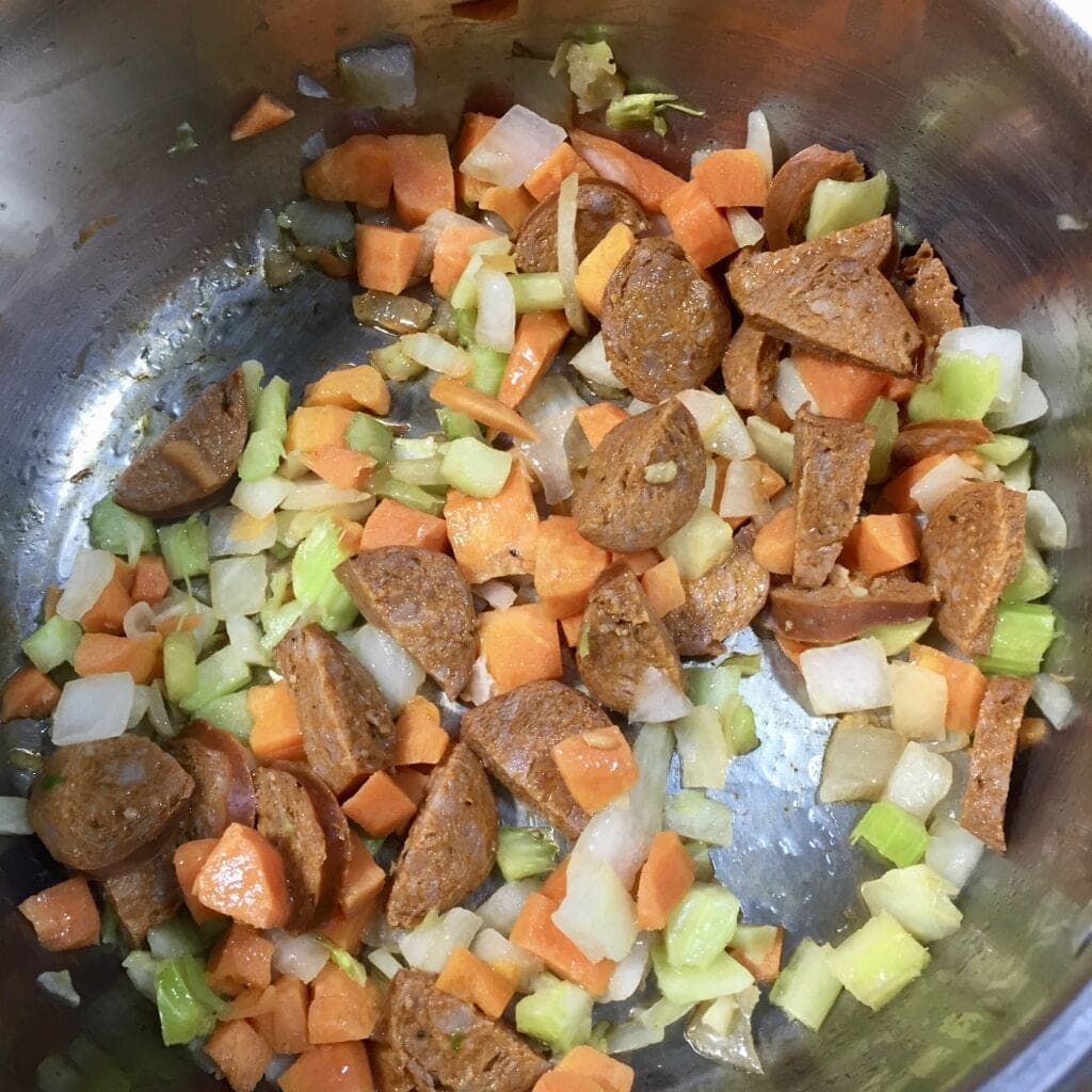 Vegetables and sausage simmering in a pot