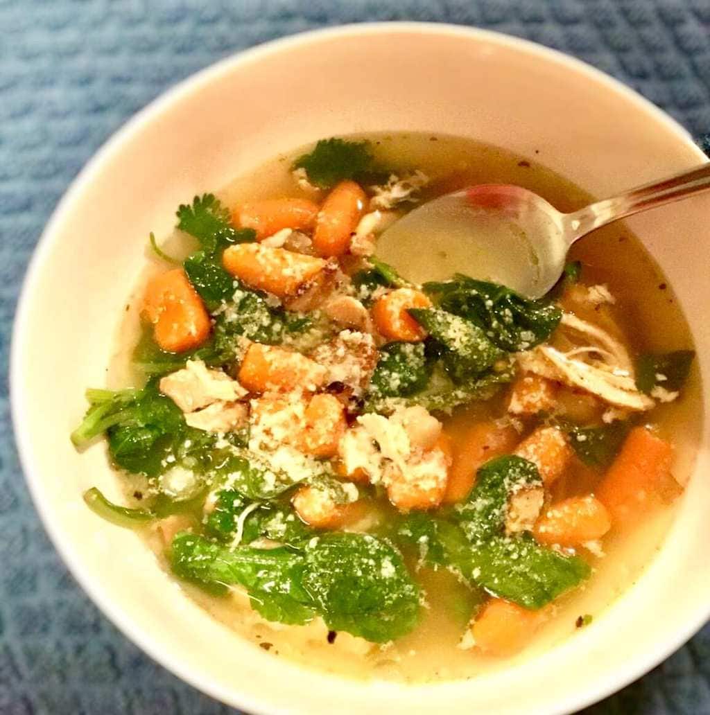 French Country Soup in a white bowl on a blue table cloth