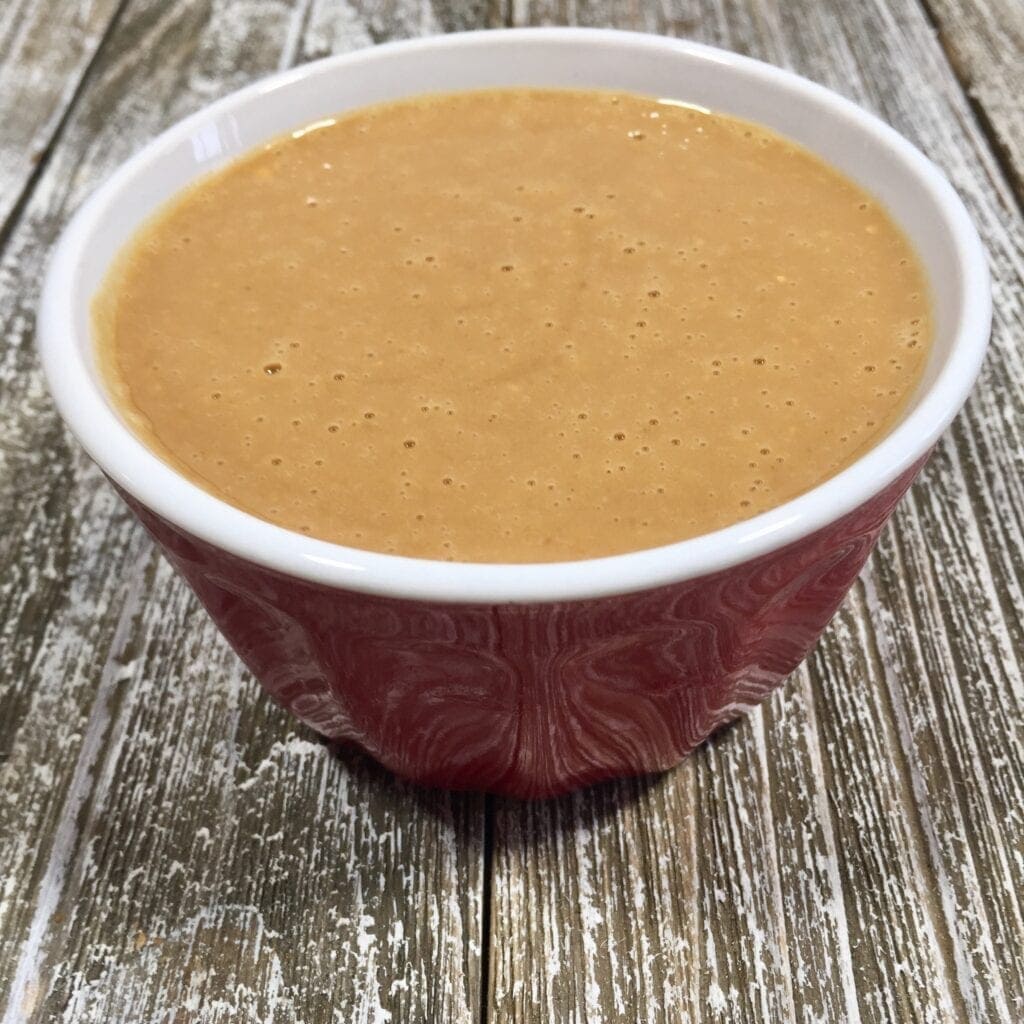 Peanut sauce in a red bowl