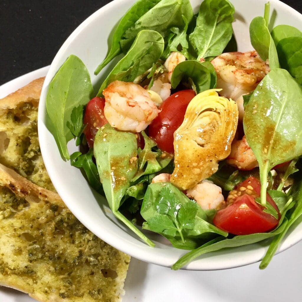 shrimp salad with ginger dressing in a white bowl