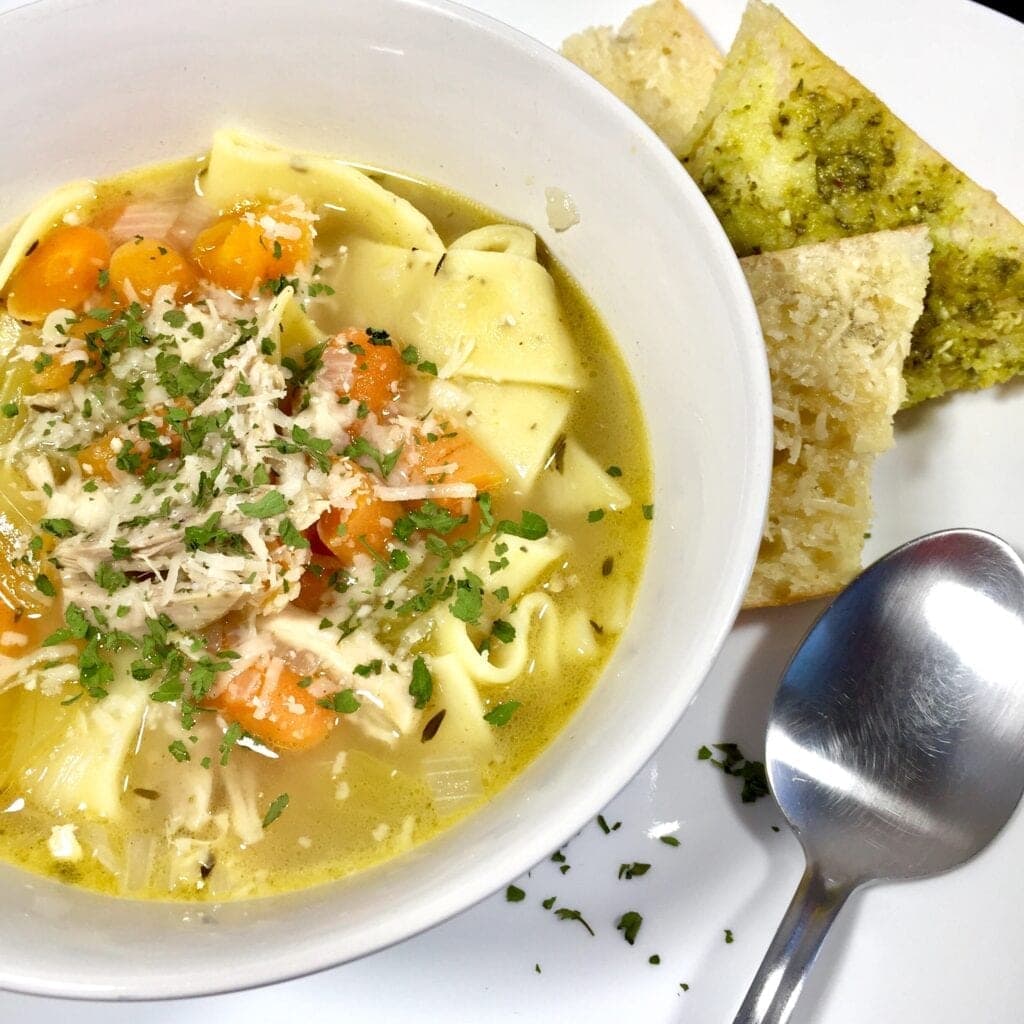 chicken noodle soup in a white bowl