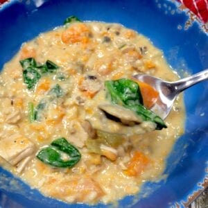 creamy chicken soup in a blue bowl