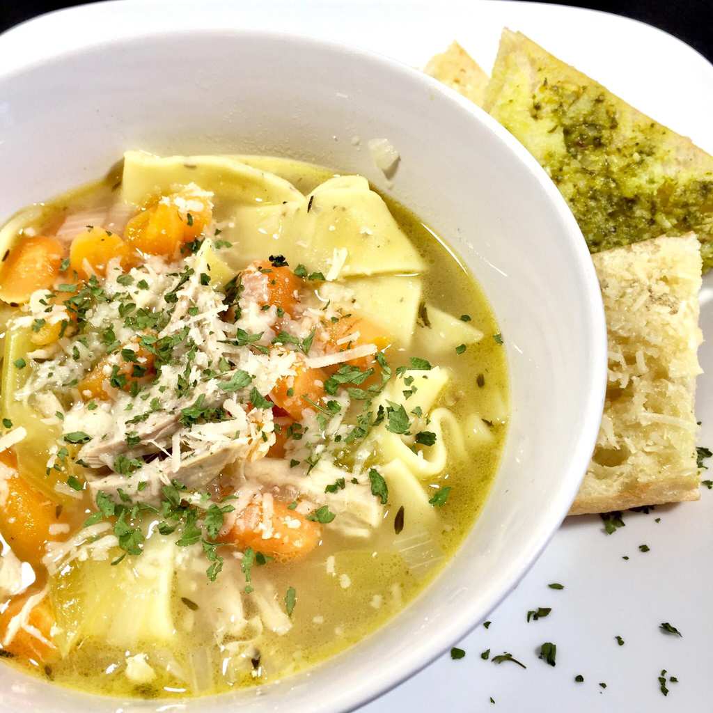 chicken noodle soup in a white bowl