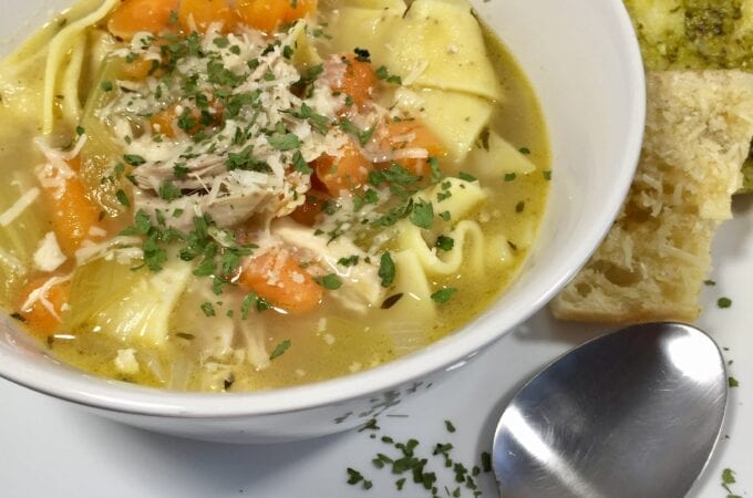 chicken noodle soup in a white bowl