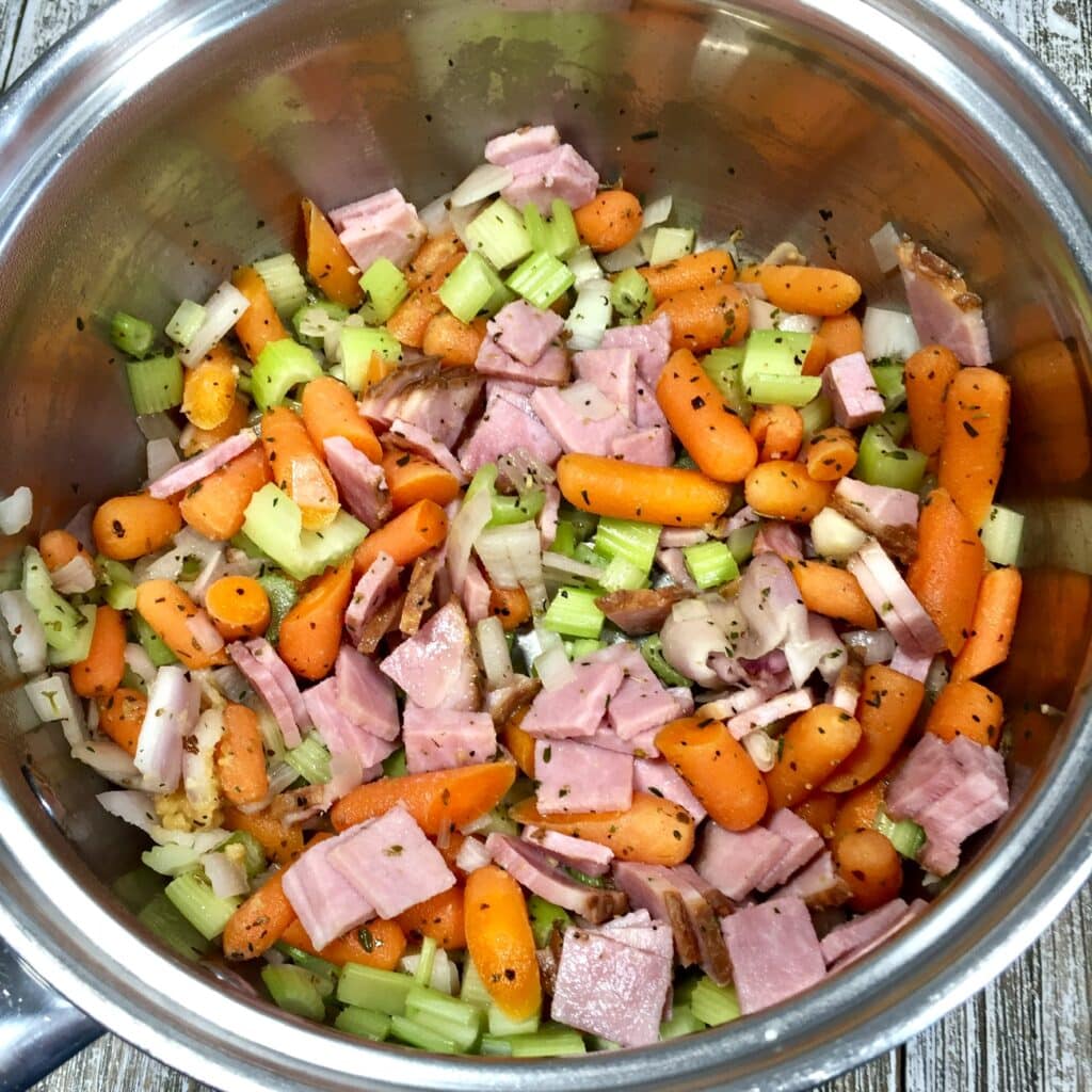 celery, onions, carrots and diced ham in a soup pot