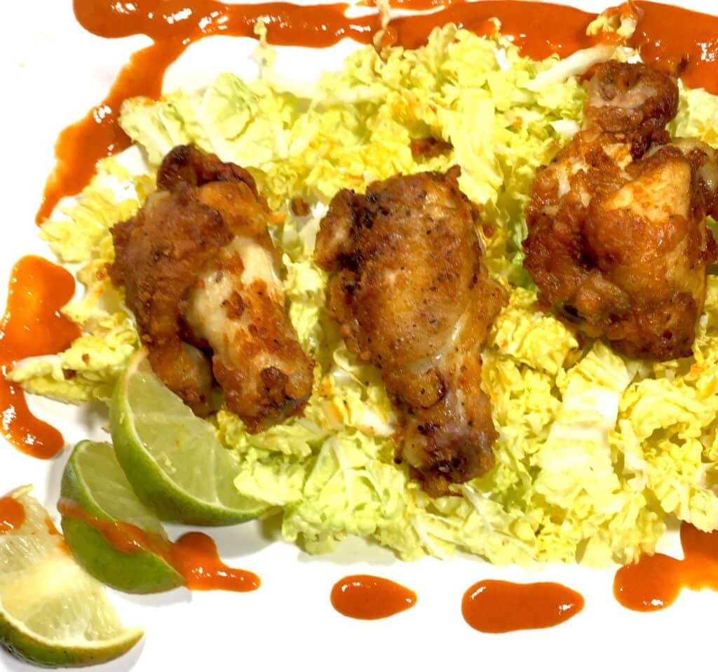 Baked Chili Lime chicken wings on a bed of lettuce