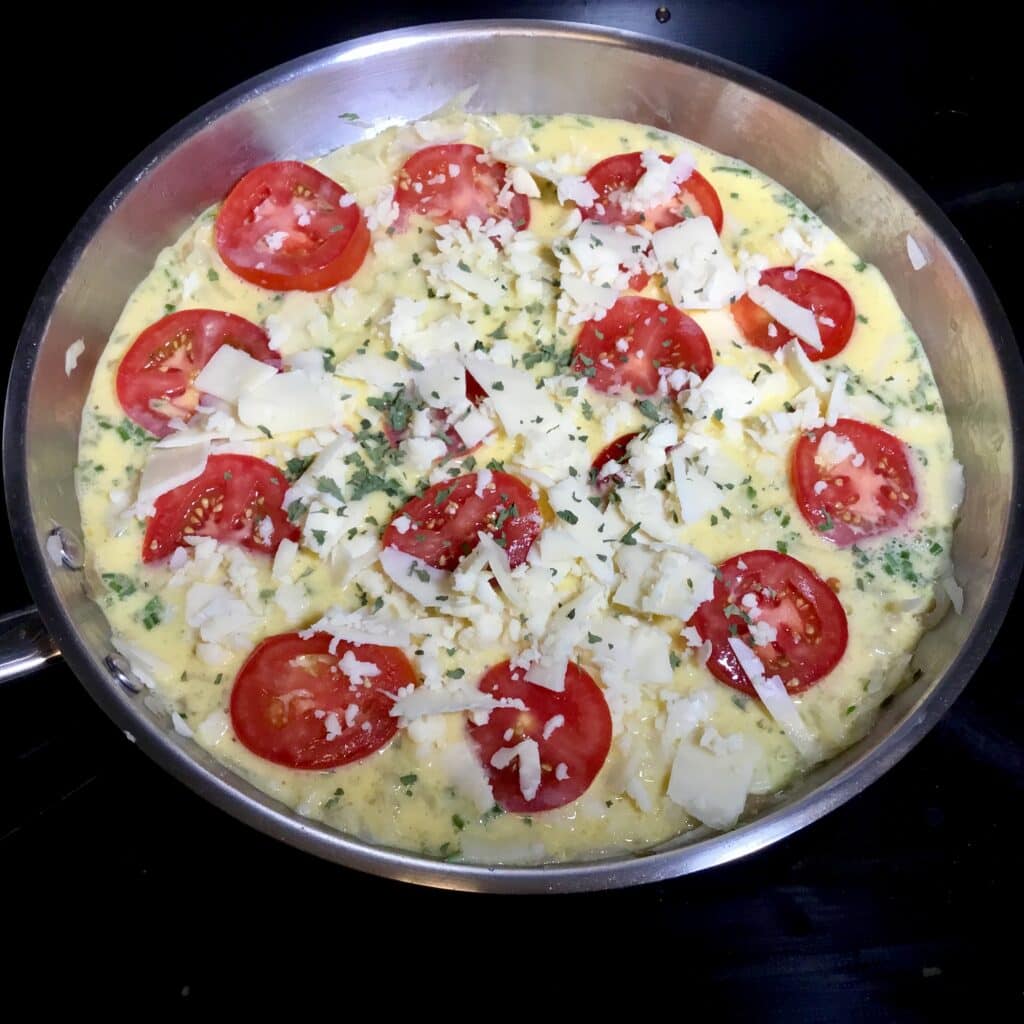 Frittata with tomatoes ready to be baked