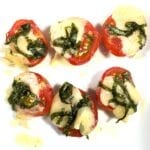 Tomatoes with melted gruyere and basil - Caprese Tomato Bites - on a white plate