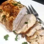 Roast turkey with Herb Butter sliced on a white plate