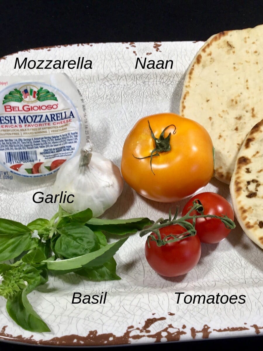 Ingredients for Naan Margherita pizza on a white plate