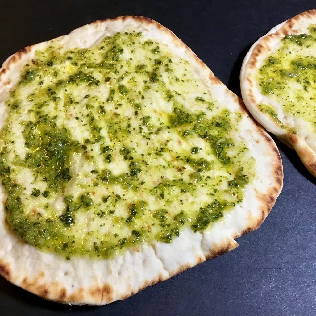 basil, garlic and olive oil spread on naan bread