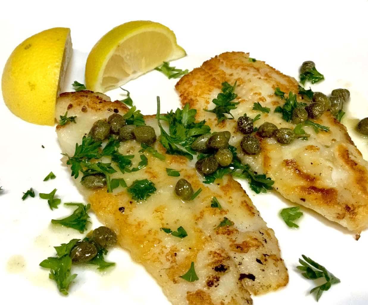 Dover Sole with lemon and capers on a white plate
