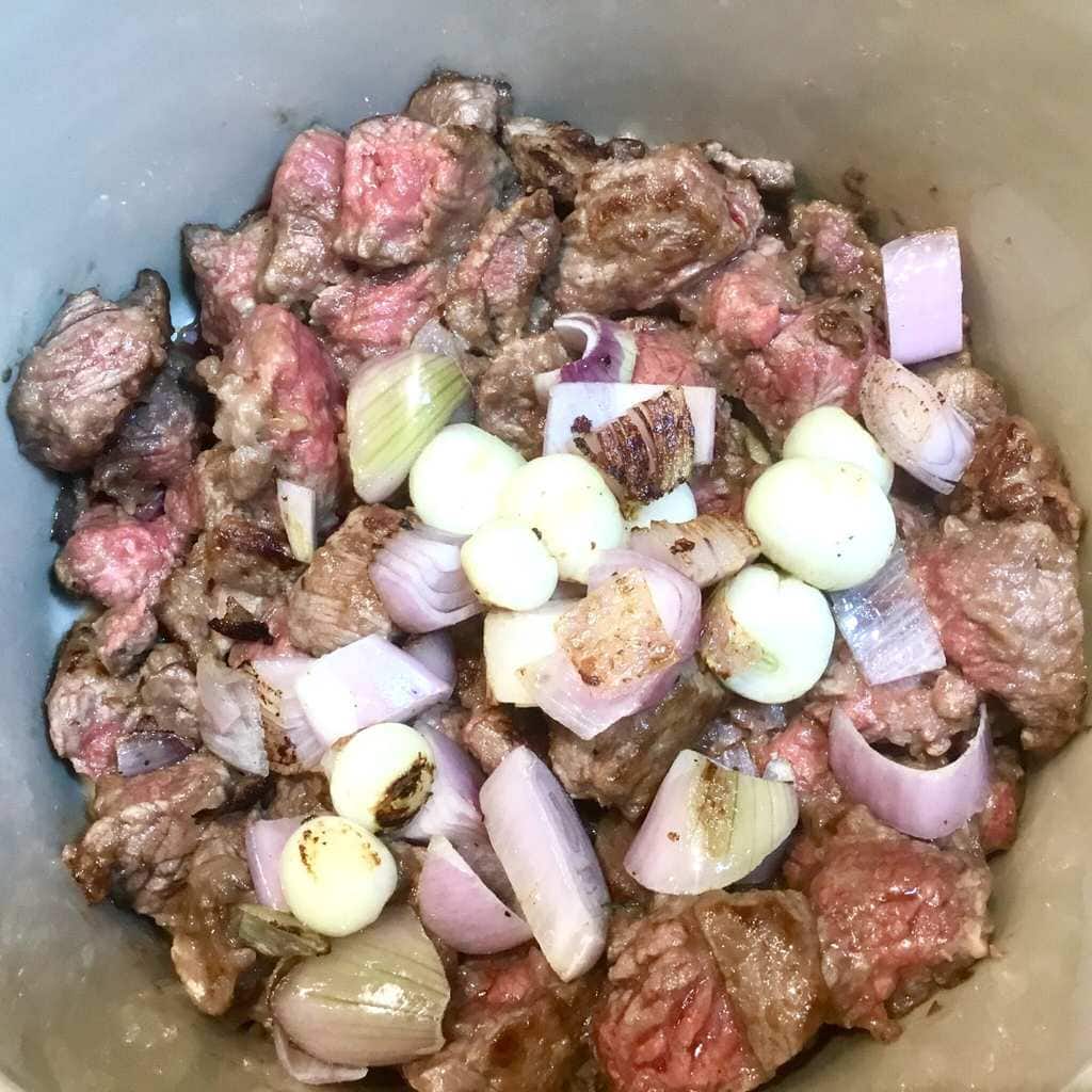 Beef stew ingredients in a Crockpot