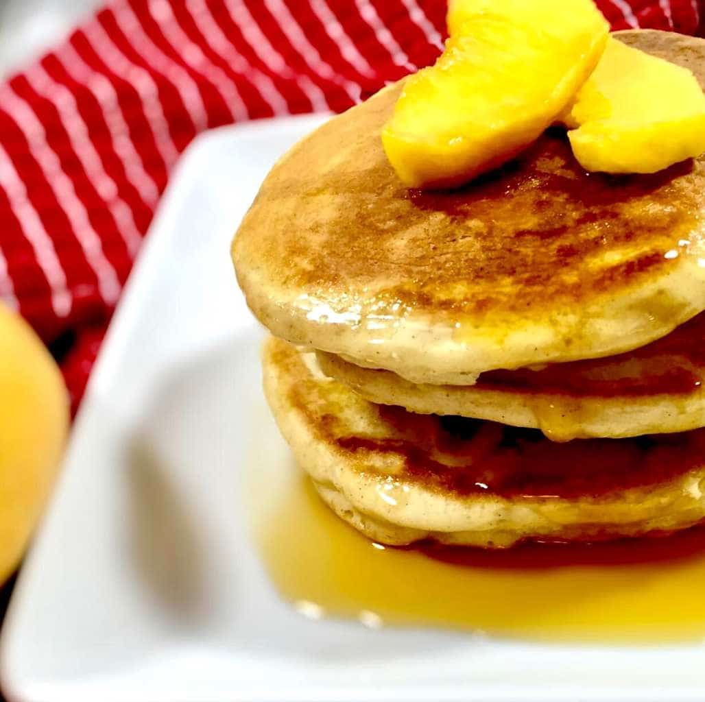 Peach cobbler pancakes on a white plate