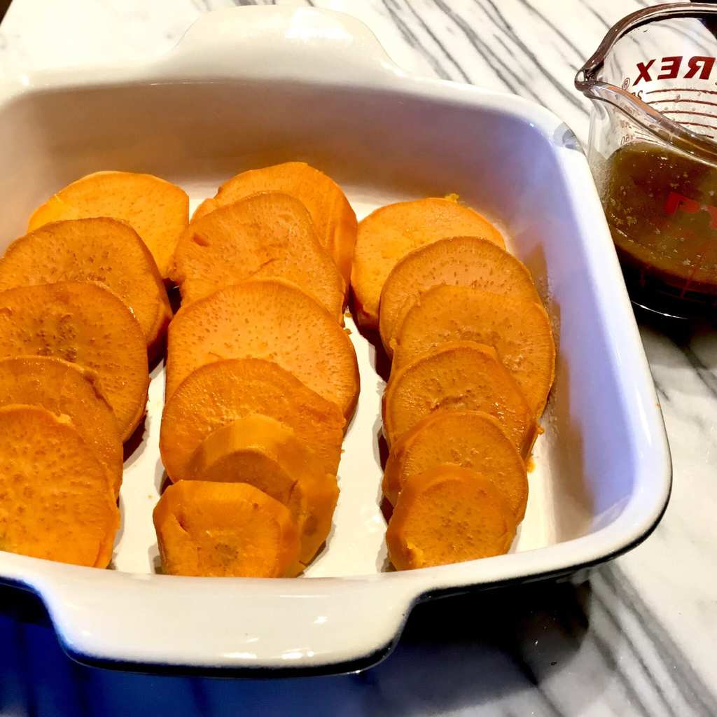 Sliced sweet potatoes in a baking dish