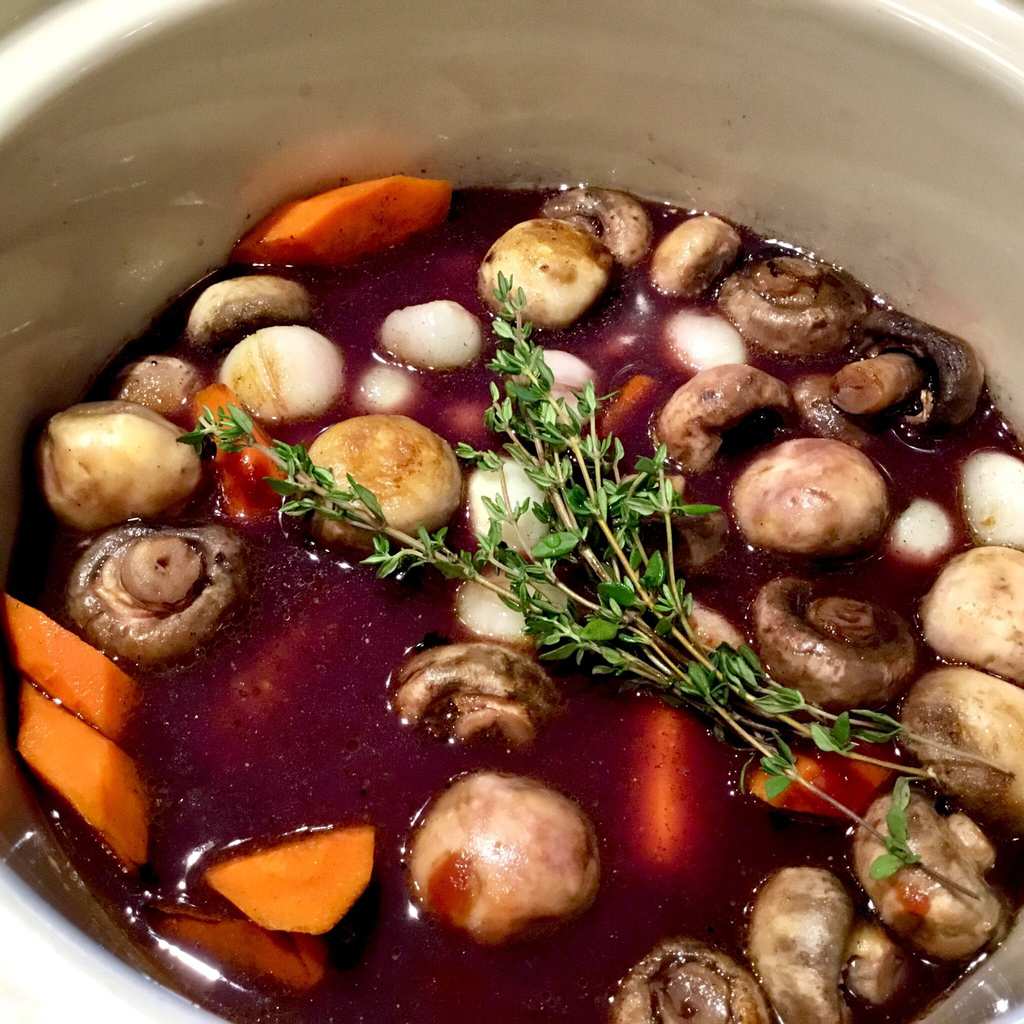 Coq au Vin simmering in a crockpot
