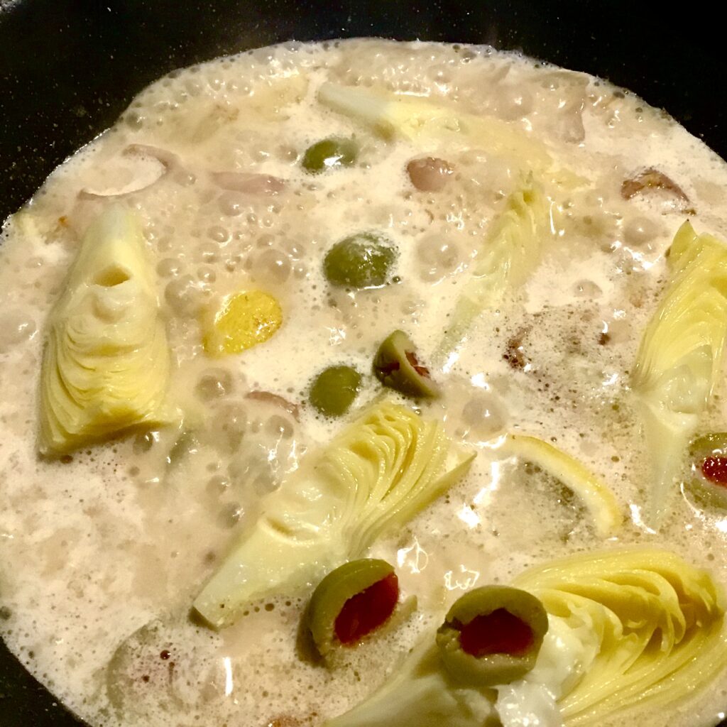 artichokes, lemons and olives in a garlic cream sauce