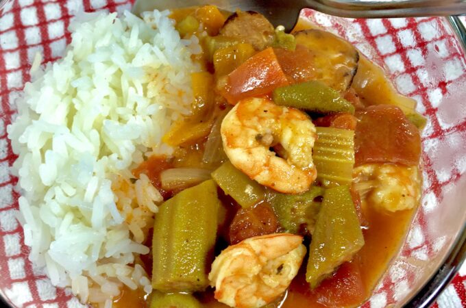 Lite Shrimp Gumbo in a clear bowl with a red and white checked towel