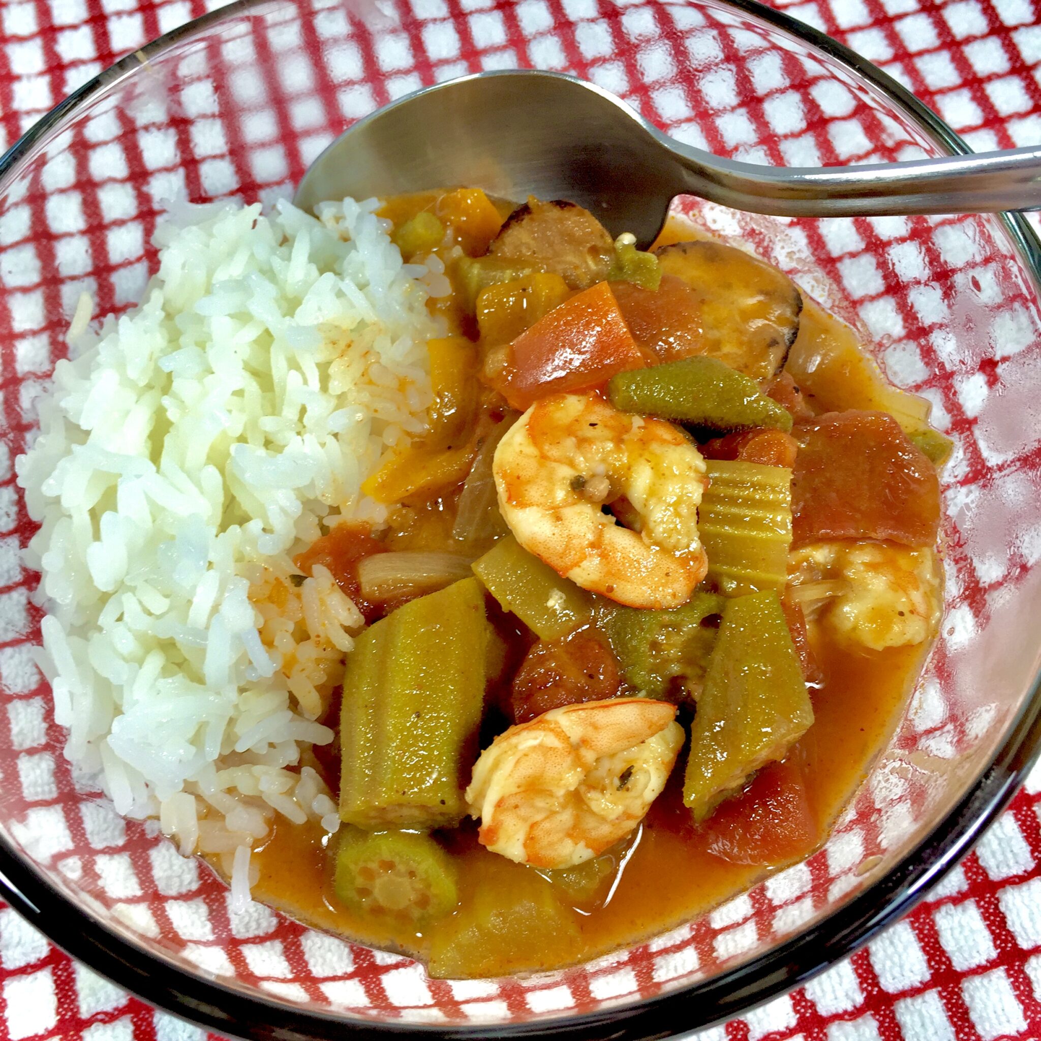 Lite Shrimp Gumbo in a clear bowl with a red and white checked towel