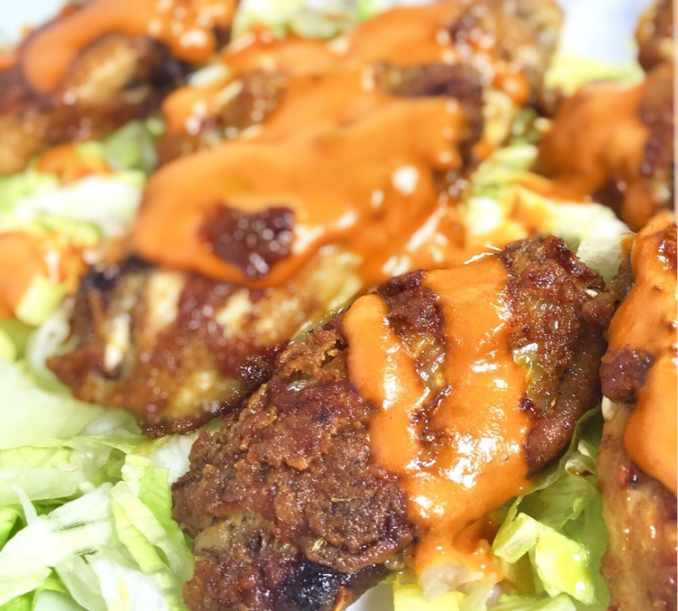 Crispy baked wings over shredded cabbage 