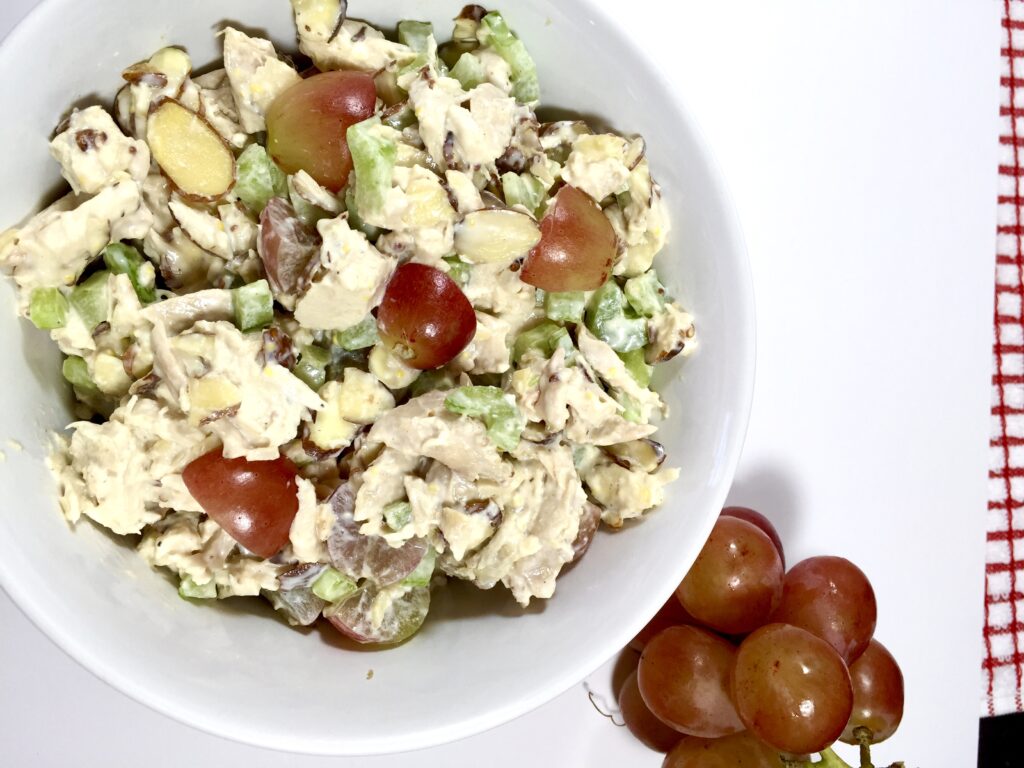 Best Ever Smoked Chicken Salad in a white bowl with Red grapes 