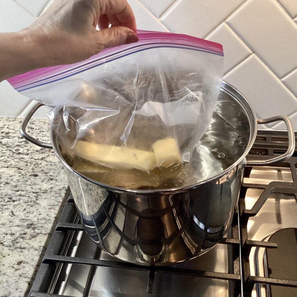 Adding butter in a zipped gallon bag to simmering water