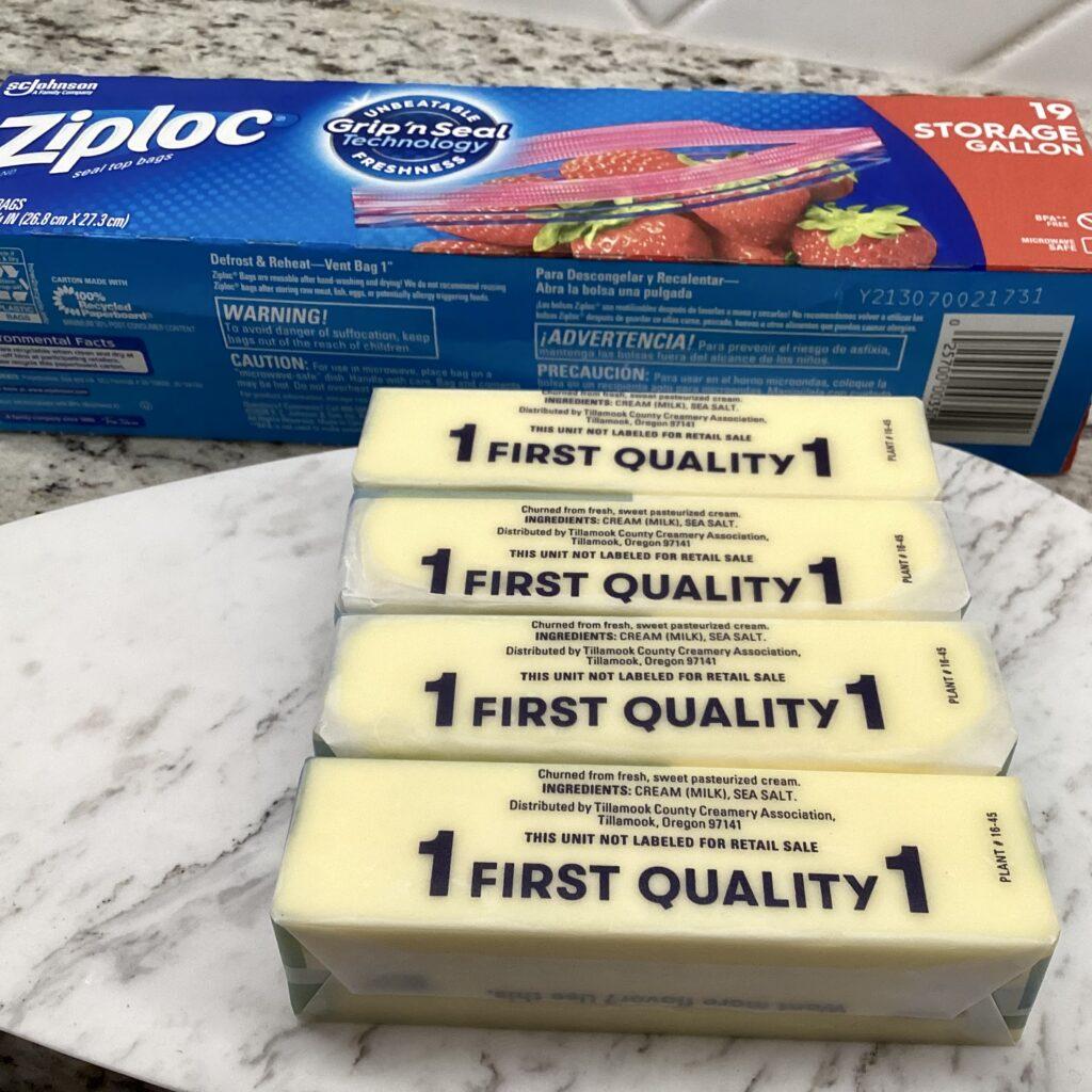 Four sticks of butter with a gallon ziplock package